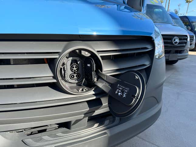 Front grille charging port of a blue Mercedes-Benz eSprinter