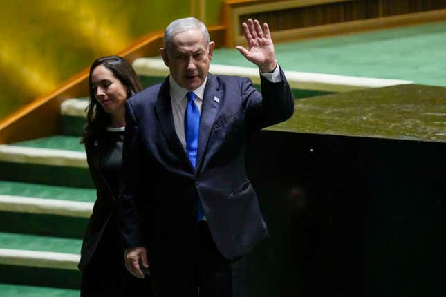 Israeli Prime Minister Benjamin Netanyahu waves at he is escorted from the stage by protocol after addressing the 78th session of the United Nations General Assembly, Friday, Sept. 22, 2023 at United Nations headquarters. (AP Photo/Mary Altaffer)