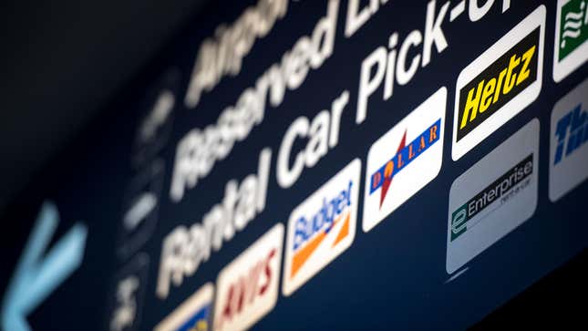 A photo of a rental car sign at an airport