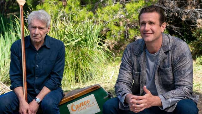 Jason Segal and Harrison Ford sit in a park. 