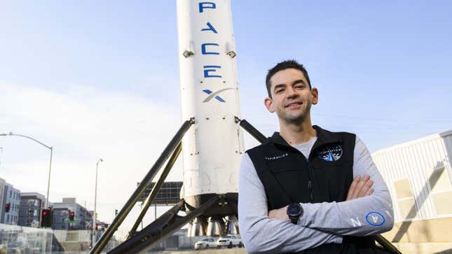 A photo of billionaire Jared Isaacman in front of a SpaceX rocket.