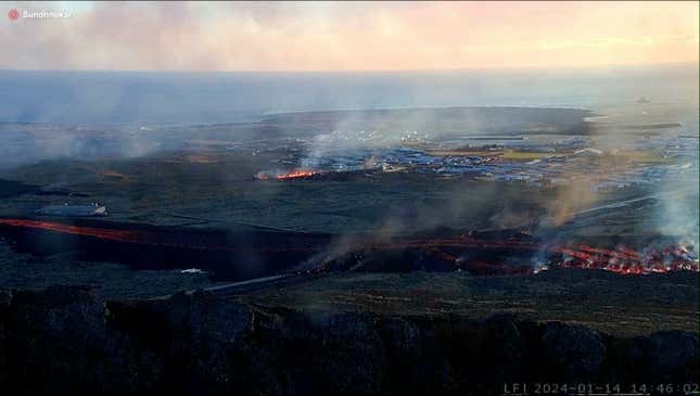 This photo provided by LIVEFROMICELAND.IS shows lava on the move toward the community from an erupting volcano in Iceland near the town of Grindavik, Iceland, Sunday Jan. 14, 2024. A volcano erupted in southwestern Iceland Sunday for the second time in less than a month, sending semi-molten rock toward a nearby settlement. The eruption just before 8 a.m. came after a swarm of earthquakes near the town of Grindavik, the Icelandic Meteorological Office said. The community was evacuated overnight. (LIVEFROMICELAND.IS via AP)