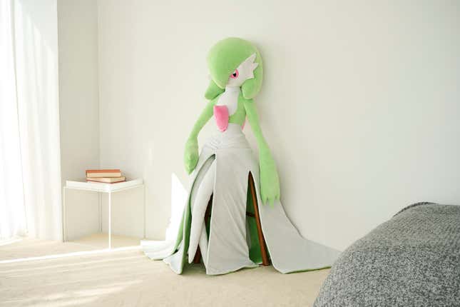 Gardevoir plush leaning against a wall.