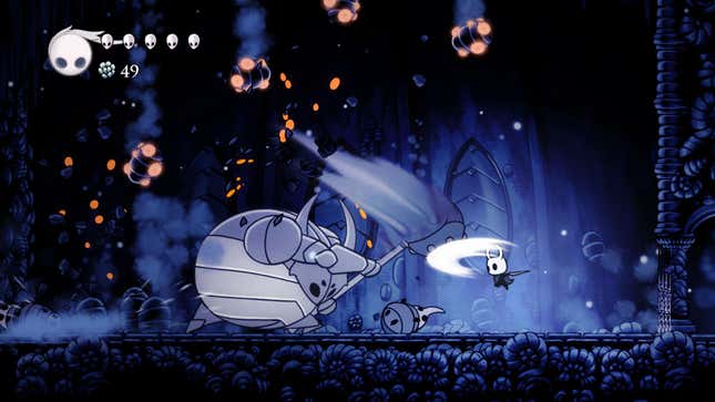 A boss fight in a blue cave in Hollow Knight.