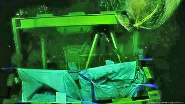 A jar (top right) being recovered from the wreck site by an ROV.