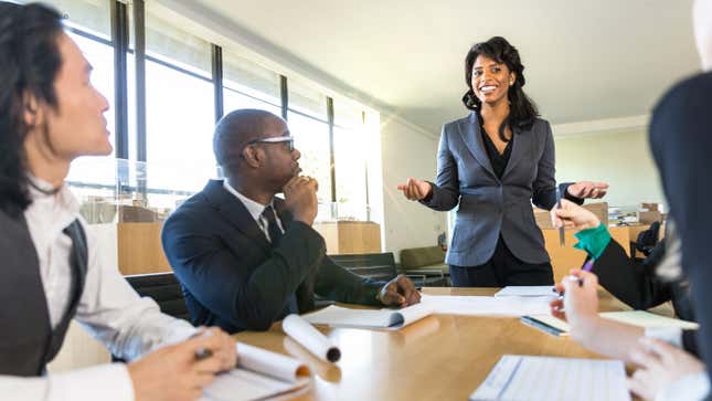 CEO boss female speaker manager presenting a lecture in the boardroom office workplace to colleagues.