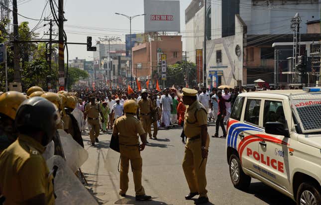 Policemen stand guard during a march by BJP activists in Thiruvananthapuram, Kerala’s capital.