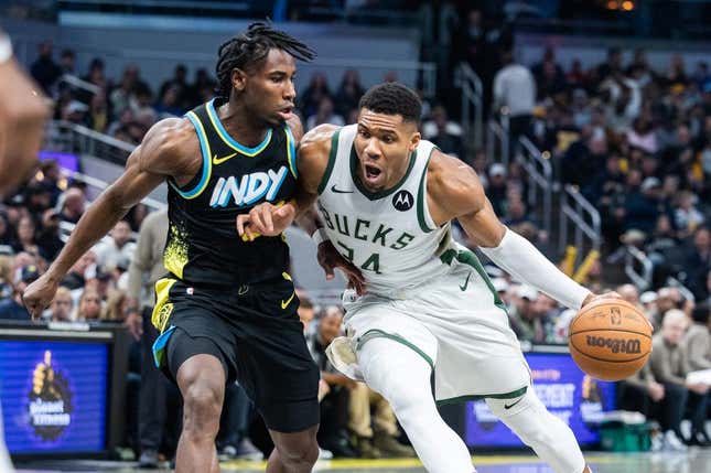 Nov 9, 2023; Indianapolis, Indiana, USA; Milwaukee Bucks forward Giannis Antetokounmpo (34) dribbles the ball while Indiana Pacers forward Aaron Nesmith (23) defends in the first quarter at Gainbridge Fieldhouse.