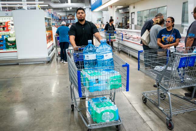 Joseph Monge collects water bottles at a Sam’s Club just over the border in El Paso, Texas. 