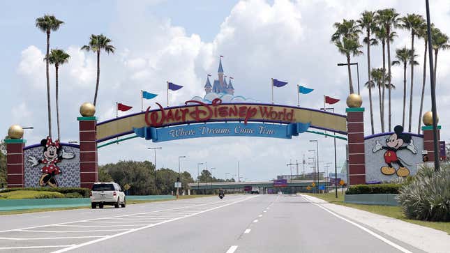 Cars drive under a sign greeting visitors near the entrance to Walt Disney World in Lake Buena Vista, Fla. 