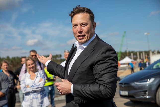 Tesla head Elon Musk talks to the press as he arrives to have a look at the construction site of the new Tesla Gigafactory near Berlin on September 03, 2020, near Gruenheide, Germany.