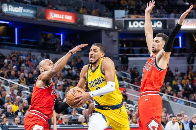 Oct 30, 2023; Indianapolis, Indiana, USA; Indiana Pacers guard Tyrese Haliburton (0) dribbles the ball while Chicago Bulls guard Jevon Carter (5) and guard Zach LaVine (8) defend in the second half at Gainbridge Fieldhouse.