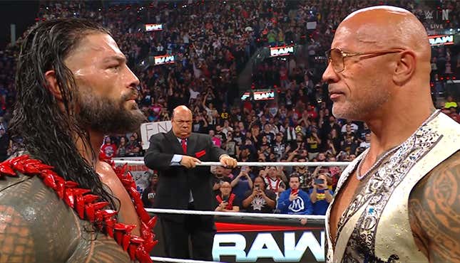 Roman Reigns (left) and The Rock (right) having a stare off