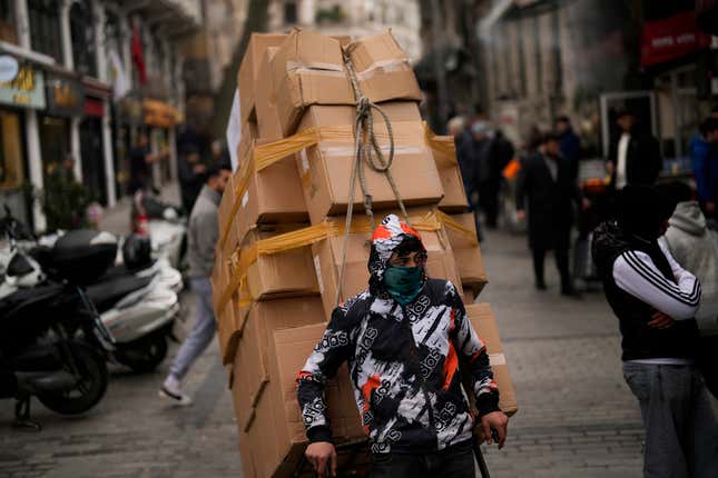 A man pulls a trolley with goods in Eminonu commercial area in Istanbul, Turkey, Thursday, Jan. 25, 2024. Turkey&#39;s central bank raised its key interest rate by another 2.5 percentage points on Thursday, pressing ahead with a series of borrowing cost increases aimed at combatting inflation that reached nearly 65% in December. (AP Photo/Francisco Seco)