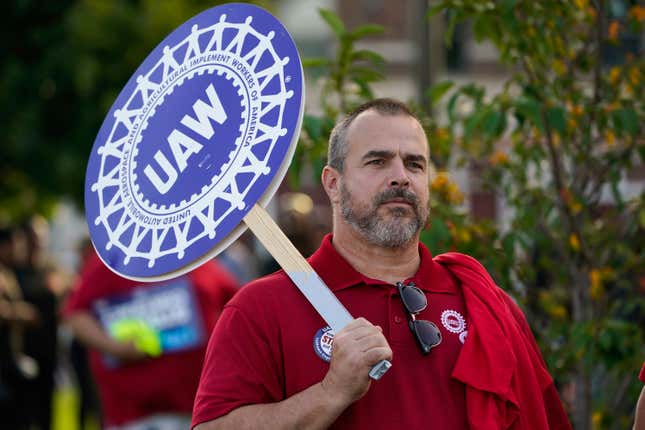 United Auto Workers member John Weyer walks in the Labor Day parade in Detroit, Monday, Sept. 4, 2023. (AP Photo/Paul Sancya)