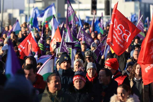 Public sector workers walk from the picket line at the Royal Victoria Hospital to a rally at Belfast City Hall, in Belfast, Thursday, Jan. 18, 2024, as an estimated 150,000 workers take part in walkouts over pay across Northern Ireland. (Liam McBurney/PA via AP)