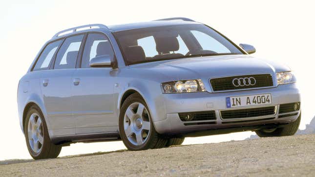 A silver Audi A4 Avant from the front 3/4 angle parked on dirt