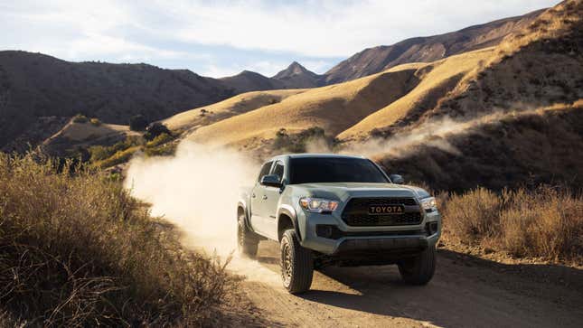 A photo of a beige Toyota Tacoma pickup truck. 