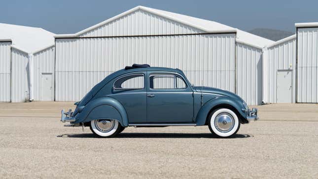 Side view of a blue vintage Volkswagen Beetle