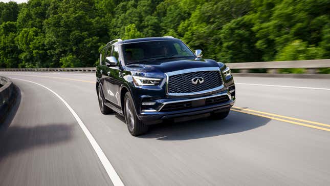 An Infiniti QX80 driving on a two-lane highway