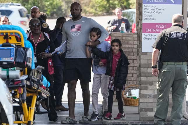 A family departs the reunification center at the Woodmont Baptist church after a school shooting, Monday, March 27, 2023, in Nashville, Tenn.