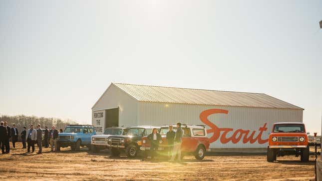 A building at the Scout Motors factory with a bunch of trucks in front of it