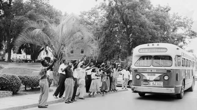 6/1/1956-Tallahassee, FL: Negro students at Florida A&M College jeer at the driver of a city bus as he drives his empty vehicle across the school campus here, June 1st. Negroes protesting segregation on the bus lines are boycotting the buses until their demands are met. 