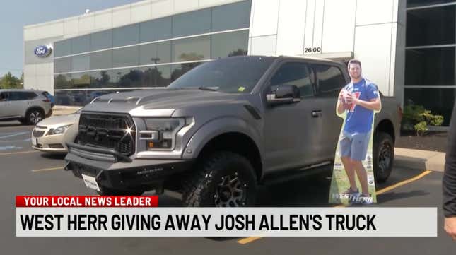 A cutout of Josh Allen placed next to his Shelby F-150 Raptor