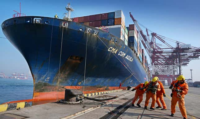 In this photo released by Xinhua News Agency, workers dock a container vessel at Qingdao Port, east China&#39;s Shandong Province on Feb. 11, 2024. China&#39;s exports and imports for the first two months of the year beat estimates, an indication that demand may be improving as Beijing attempts to speed up its economic recovery. (Li Ziheng/Xinhua via AP)