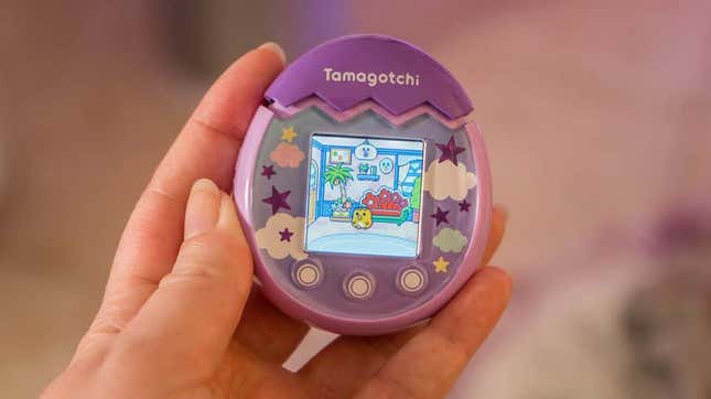 A photo of a person holding the Tamagotchi Pix