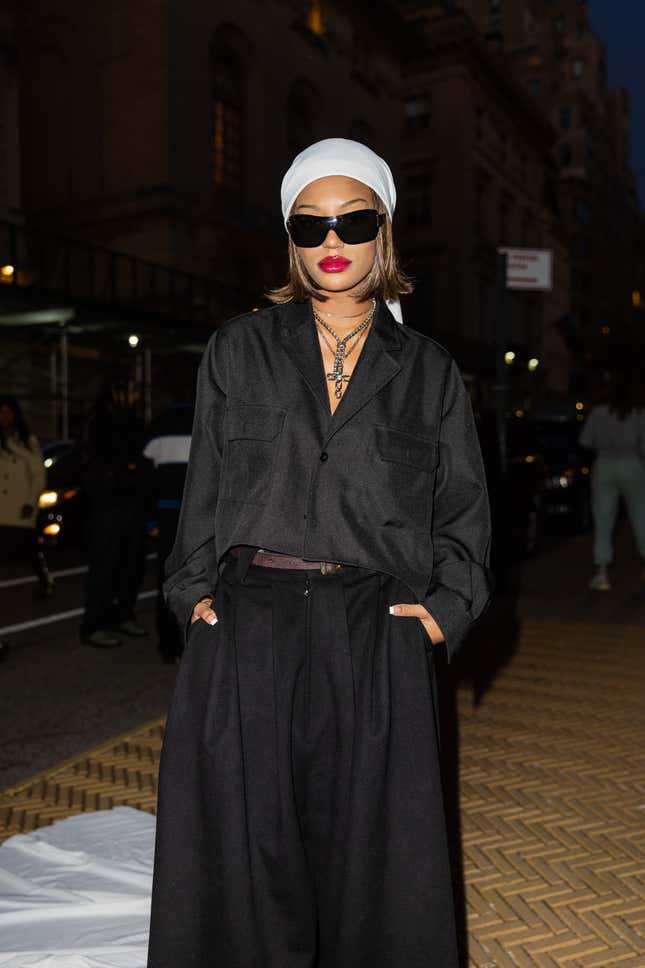 NEW YORK, NEW YORK - FEBRUARY 15: Savannah Lee Smith wears white head scarf, black oversized button shirt, wide leg pants outside Willy Chavarria New York Fashion Week during on February 15, 2023 in New York City. 