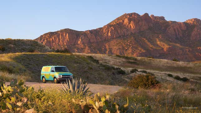 The Mystery Machine is shown with mountains in the background.