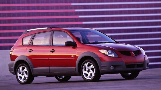 A photo of a red Pontiac Vibe station wagon. 