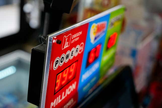 A sign for the Powerball jackpot is displayed at a 7-Eleven, Friday, April 5, 2024, in Portland, Ore. (AP Photo/Jenny Kane)