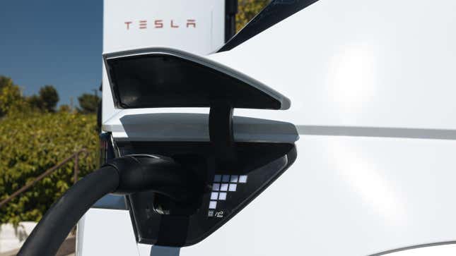 A close up of the charge port on a white Ioniq 5 charging at a tesla charger