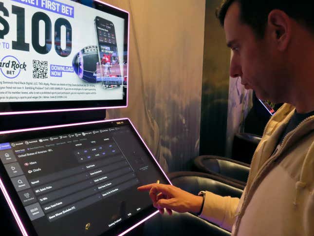 Matt Smircich, of Hamburg, N.J., makes sports bets at the Hard Rock casino in Atlantic City, N.J., Friday, Feb. 2, 2024. On Tuesday, Feb. 6, 2024, the American Gaming Association estimated that a record 68 million Americans would wager a total of $23.1 billion on this year&#39;s Super Bowl, legally or otherwise. (AP Photo/Wayne Parry)