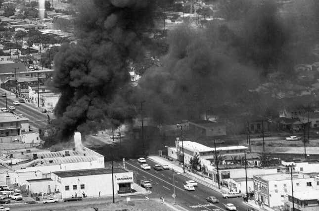 Three stores burn to the ground on Avalon Boulevard in Watts as the fire department was unable to get to the scene of the fire due to rioting . Acting Governor Glenn Anderson has ordered the National Guard to help put down the violence.