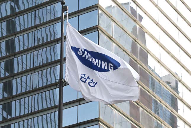 Samsung flag flying outside a tall glass building