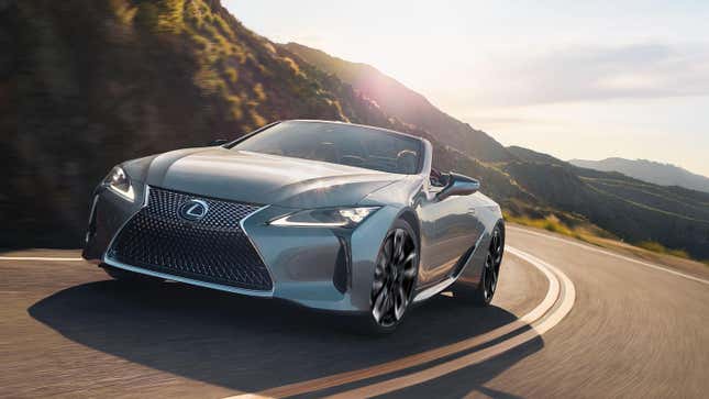 A silver Lexus LC 500 driving around a corner on a mountainous road