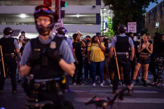 Community members face off against police, Sunday, June 6, 2021, in Minneapolis, for Winston Boogie Smith Jr., who was fatally shot by members of a U.S. Marshals task force several days earlier. 