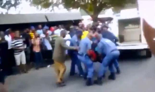 Police officers arresting Mido Macia, 27, a taxi driver in Mozambique.
