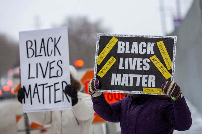 Demonstrators hold “Black Lives Matter” signs in front of the US District Court in St Paul, Minnesota, on February 24, 2022.