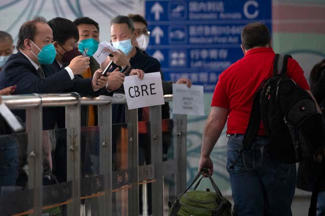 FILE - People wearing face masks wait at the international passenger arrivals area at Beijing Capital Inernational Airport in Beijing, on March 15, 2023. China announced Friday, Nov. 24, 2023 that it will allow visa-free entry for citizens of five European countries and Malaysia as it tries to encourage more people to visit for business and tourism. (AP Photo/Mark Schiefelbein, File)