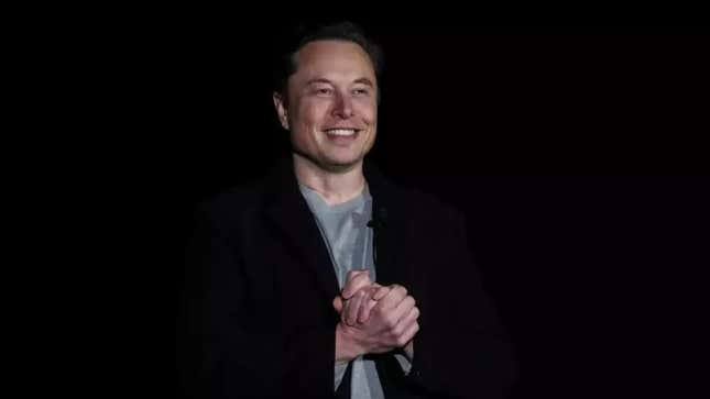 A photo of Elon Musk talking on stage. 