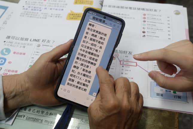 Volunteers of Fake News Cleaner guide students through the LINE app to identify fake news during a class in Kaohsiung City, southern Taiwan, Thursday, March 16, 2023. An anti-misinformation group in Taiwan called Fake News Cleaner has hosted more than 500 events, connecting with college students, elementary-school children — and the seniors that, some say, are the most vulnerable to such efforts. (AP Photo/Chiang Ying-ying)