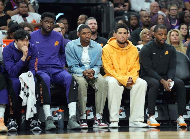 Oct 28, 2023; Phoenix, Arizona, USA; Bradley Beal (blue shirt) and Devin Booker (orange shirt) look on against the Utah Jazz during the first half at Footprint Center.