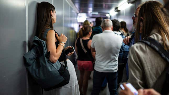 Passengers wait to board a plane