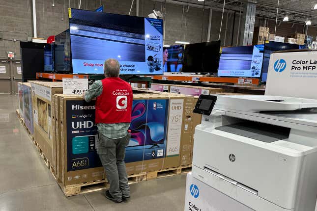 An associate checks over a big-screen television on display in a Costco warehouse Tuesday, Feb. 6, 2024, in Colorado Springs, Colo. On Tuesday, The Labor Department issues its report on inflation at the consumer level in January. (AP Photo/David Zalubowski)