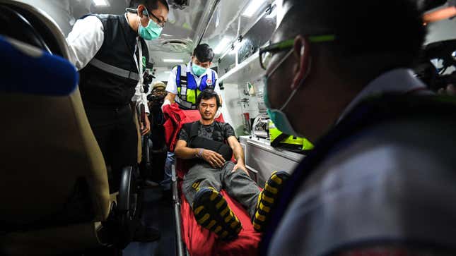 Katchakorn Pudtason, a migrant agricultural worker who was injured by a surprise attack on Israel by the Palestinian militant group Hamas, is helped by medical workers, as he arrives after being repatriated from Israel at Bangkok's Suvarnabhumi Airport, Thailand, October 12, 2023.