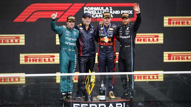 A photo of Fernando Alonso, Adrian Newey, Max Verstappen and Lewis Hamilton on the podium. 